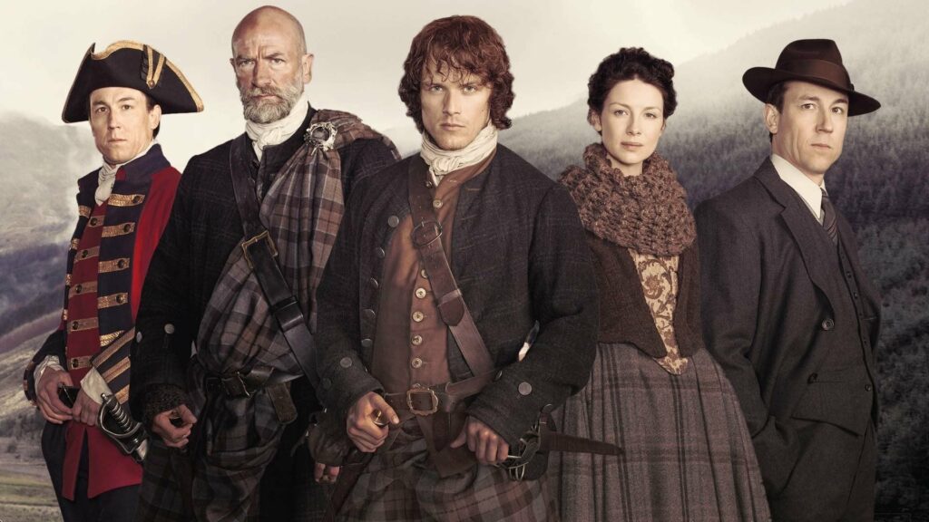 A British soldier, two highlander men, a woman and a modern man standing together