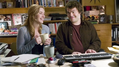 A woman and a man sitting at a keyboard together