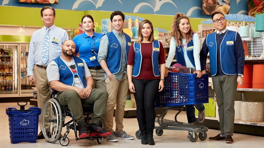 A group of blue-vested store employees standing together