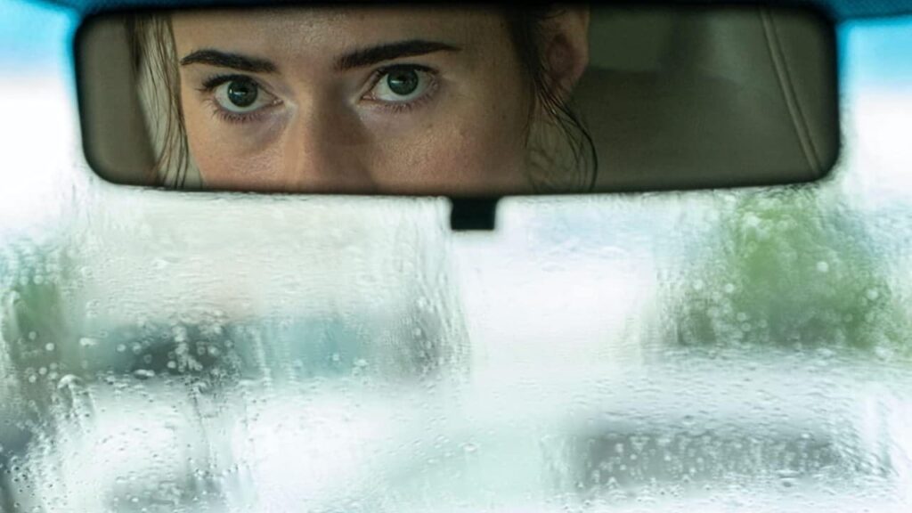 A woman looking into her rearview mirror
