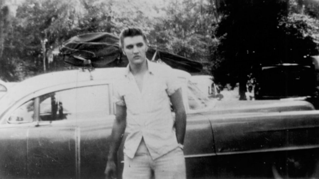Young Elvis Presley with his first car