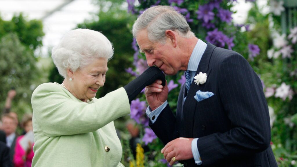 Prince Charles kissing the hand of the Queen