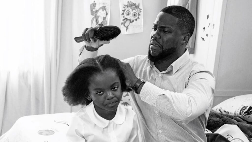 A dad struggling to do his young daughter's hair