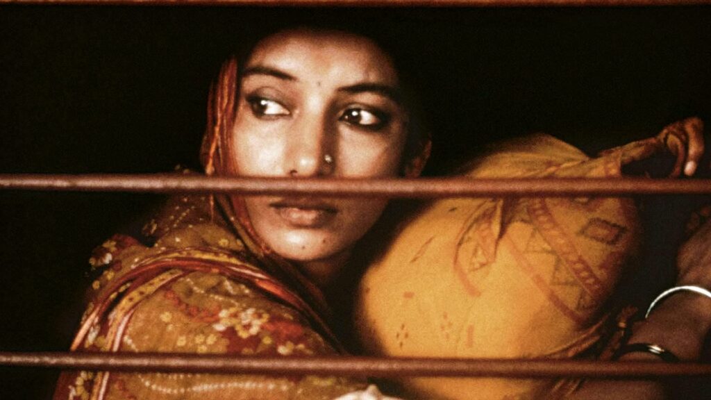 An Indian woman staring out of a train car window