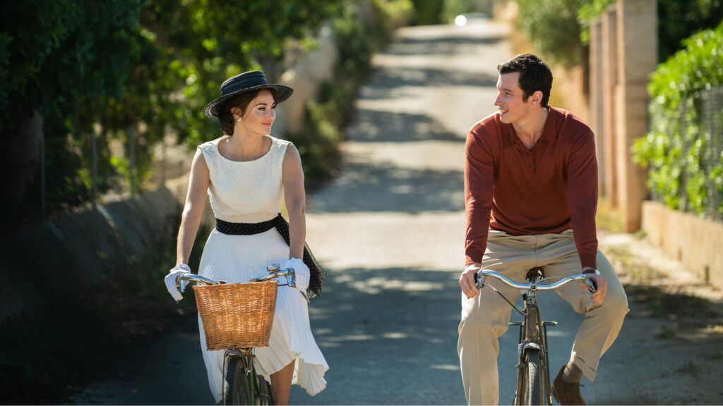 a man and woman riding bikes together